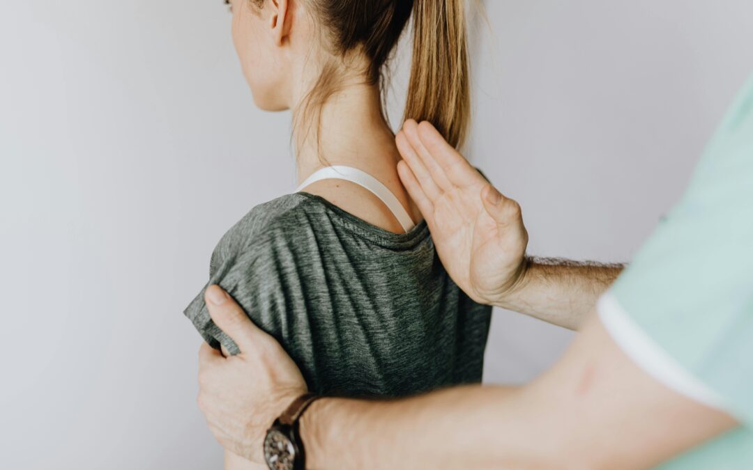 A professional chiropractor performing a manual spinal adjustment on a patient to restore alignment.